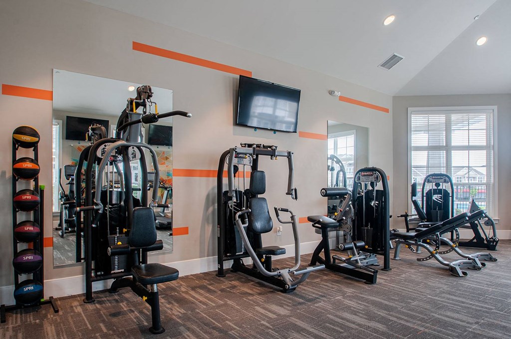 a gym with cardio equipment and a flat screen tv  at Madison Providence, Collegeville, Pennsylvania