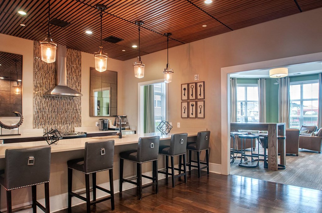 a bar area with stools and a counter with a sink  at Madison Providence, Pennsylvania, 19426