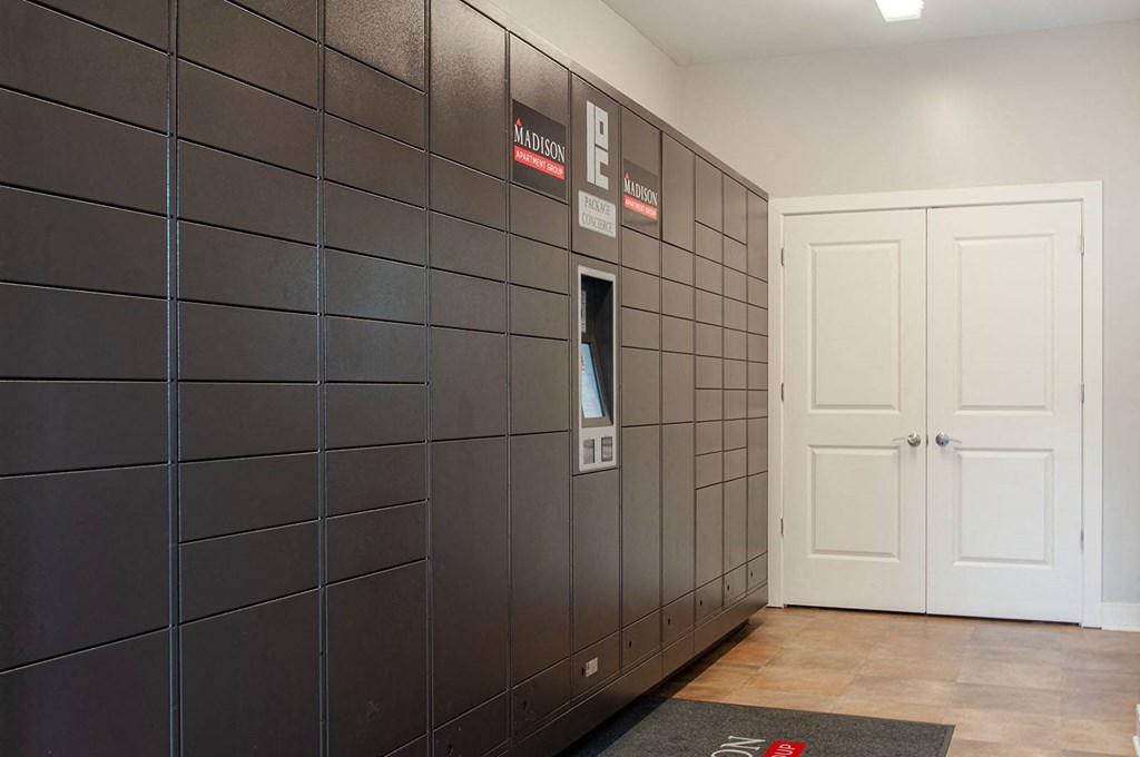 a row of lockers in a room with a door open  at Madison Providence, Collegeville, 19426