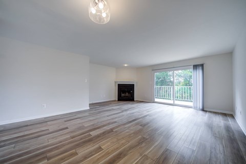 A room with a fireplace and sliding glass doors.