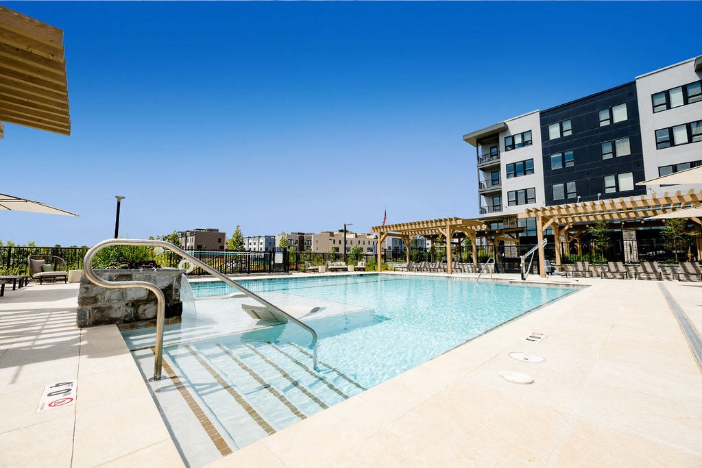 a swimming pool with a building in the background at The Harrison, Pennsylvania, 19073