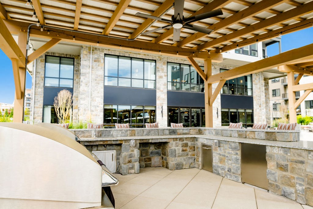 a patio with a bar and a building with large windows at The Harrison, Pennsylvania, 19073