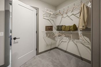 A white door is open to a hallway with a coat hanging on a rack at Madison West Elm, Conshohocken, 19428