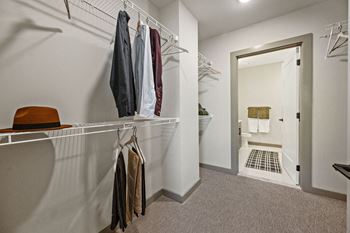 A white closet with clothes hanging on a rail at Madison West Elm, Conshohocken Pennsylvania