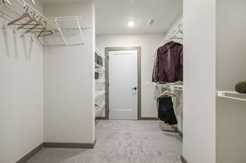 a walk in closet in a home with white walls and a white closet door at Madison West Elm, Pennsylvania