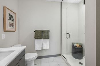 A bathroom with a toilet, sink, and shower at Madison West Elm, Conshohocken
