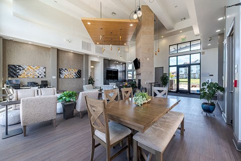 A modern dining room with a wooden table and chairs.