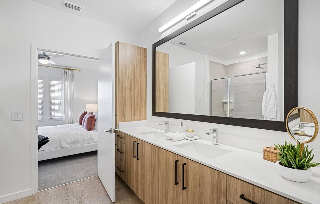 a bathroom with a large mirror and a sink at Madison Waterford Lakes, Orlando, FL
