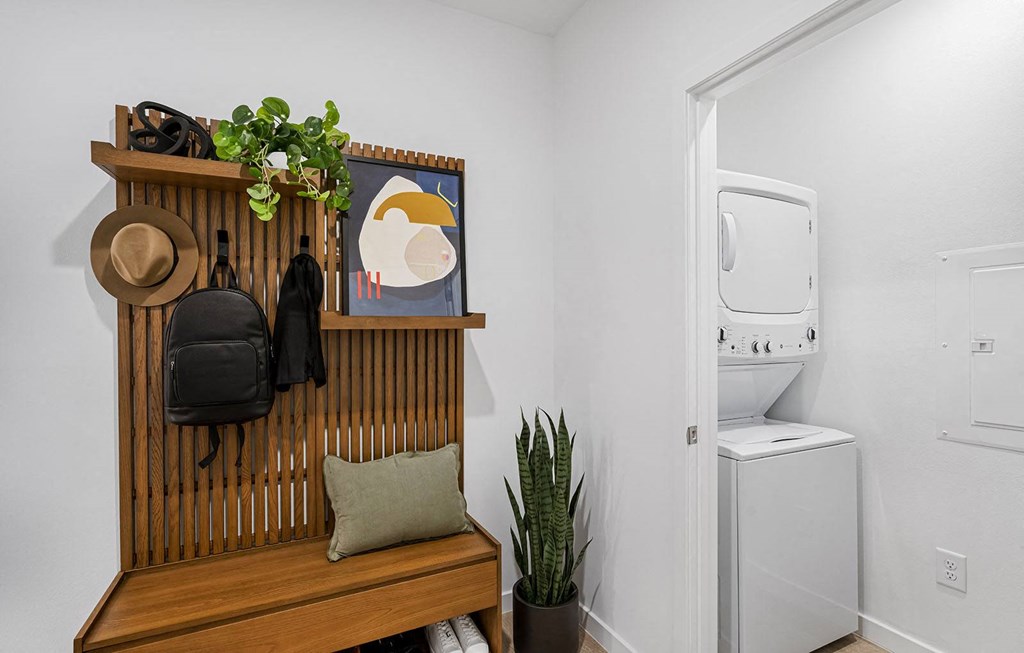 a small bathroom with a wooden shelf and a washing machine at Madison Waterford Lakes, Florida, 32826