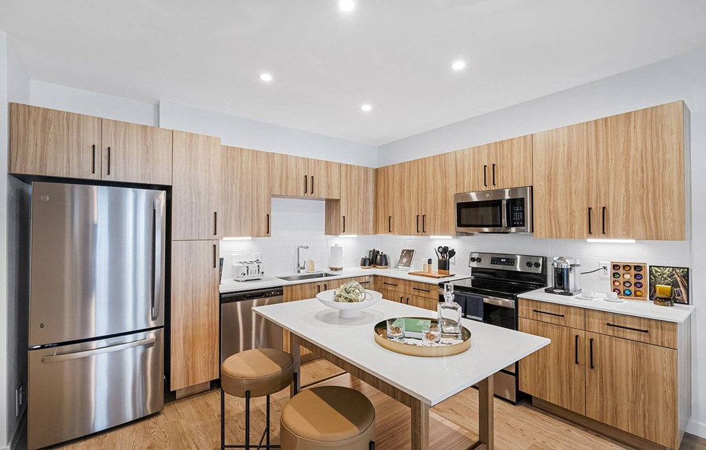 a kitchen with a center island and a stainless steel refrigerator at Madison Waterford Lakes, Orlando, FL, 32826