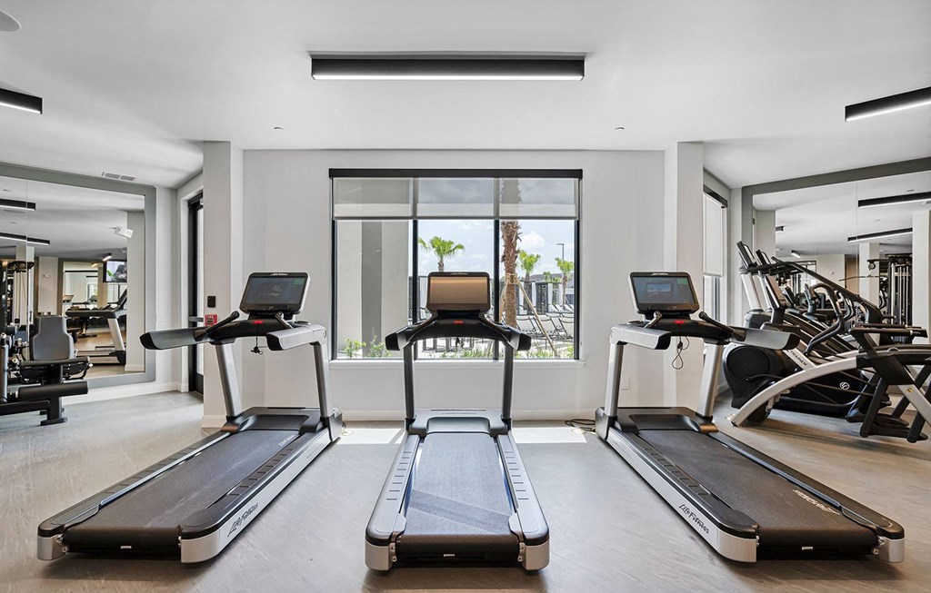 the gym is equipped with treadmills and other exercise equipment at Madison Waterford Lakes, Orlando, FL, 32826