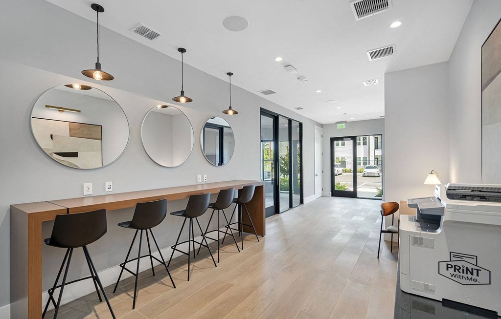 a bar with chairs and three mirrors in a room at Madison Waterford Lakes, Orlando, FL