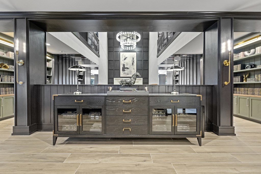 a large black credenza with gold handles and drawers in front of a large mirror at The Harrison, Newtown Square, PA, 19073