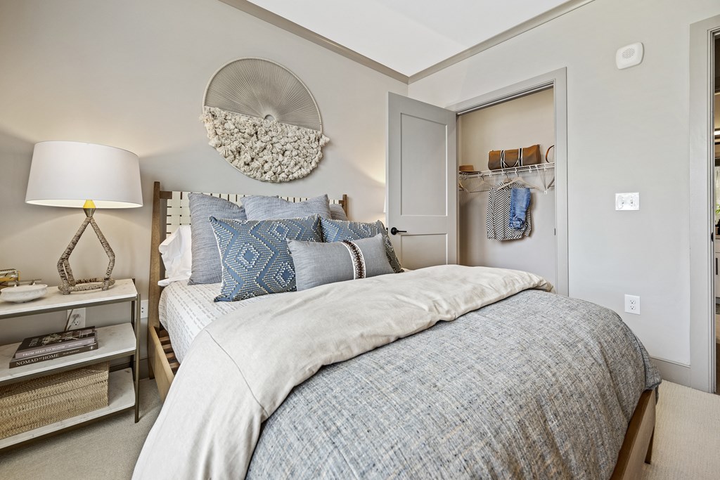 a bedroom with a bed and a nightstand with a lamp at The Harrison, Newtown Square, 19073