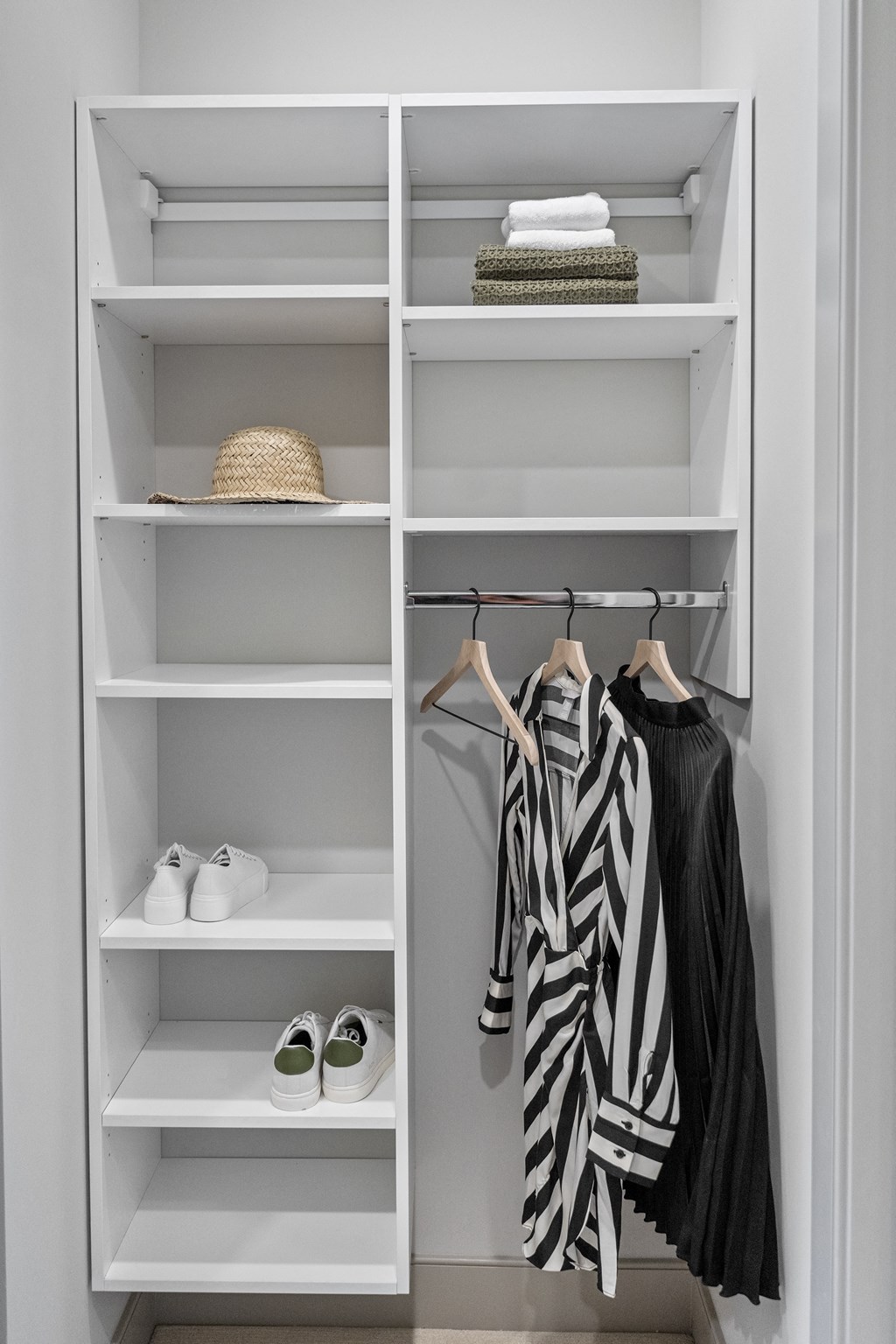 a walk in closet with white shelves and a white closet organizer with a zebra print shirt at The Harrison, Pennsylvania, 19073