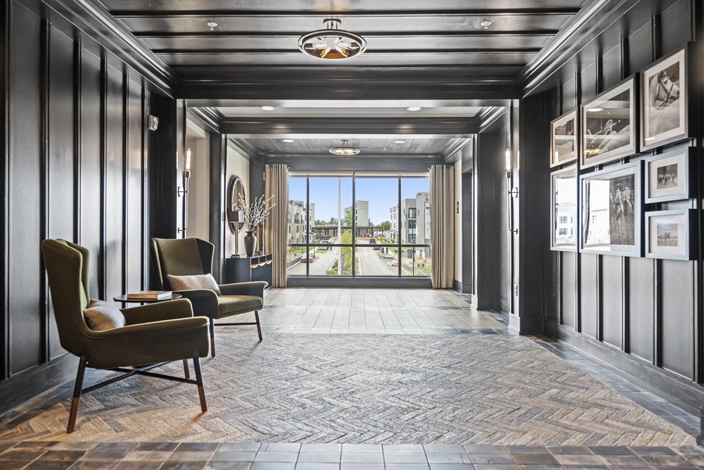 a hallway with black walls and a large glass door with a view of the city at The Harrison, Newtown Square, PA