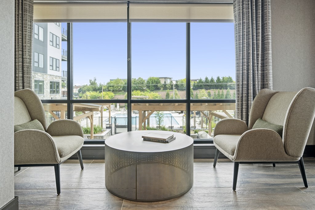 a seating area with two chairs and a coffee table in front of a window at The Harrison, Pennsylvania, 19073