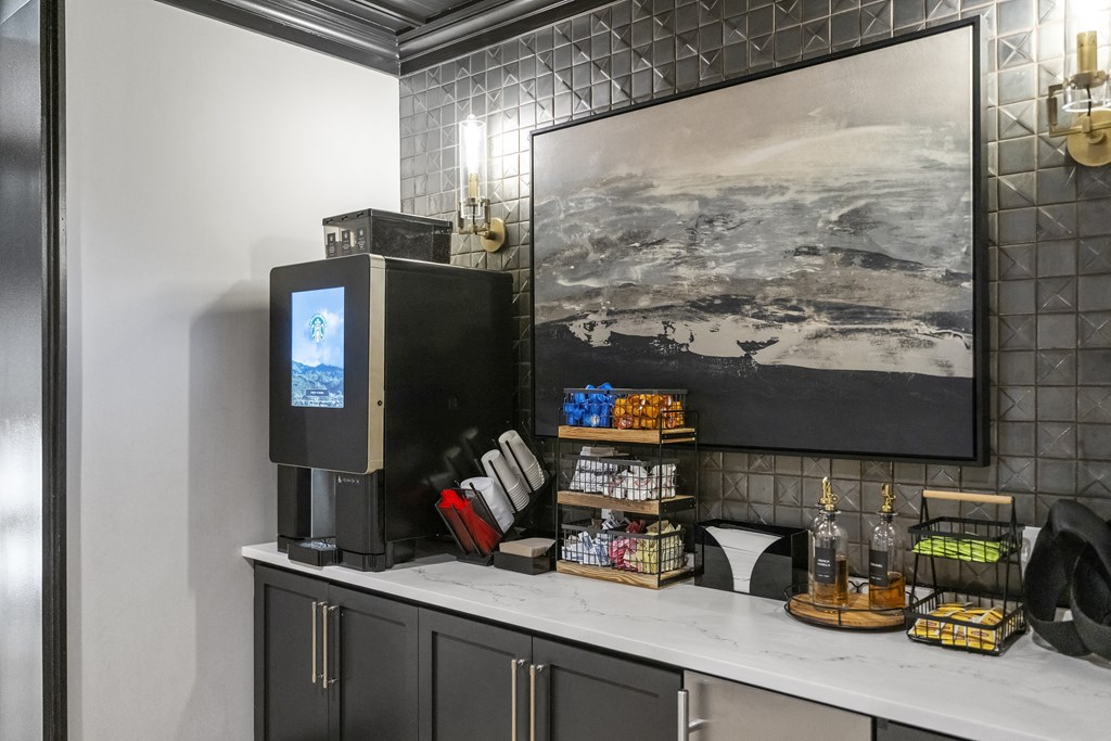 a coffee bar with a television and a painting on the wall at The Harrison, Newtown Square