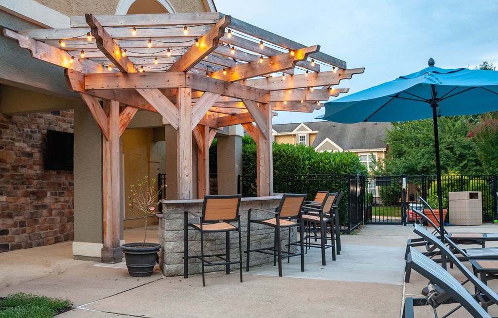 Pool Bar with TV at dusk with the lights on at Madison Glen Mills, Glen Mills, PA