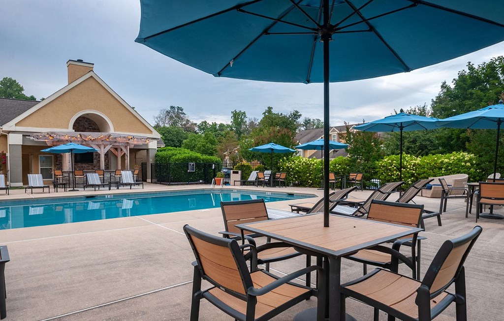 table and chairs under umbrella at the pool at Madison Glen Mills, Glen Mills, Pennsylvania