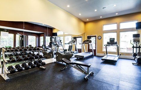 Fitness center with cardio equipment and strength training area at Madison Sierra Sun, Puyallup, WA