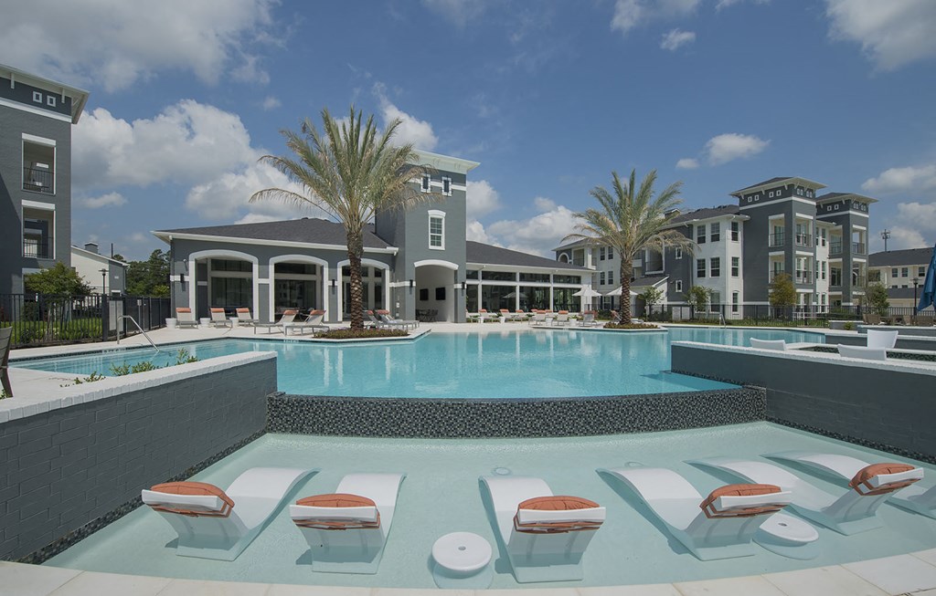 Pool with in-water seating and sun lounge  at The Parkway on Westlake, Texas, 77346
