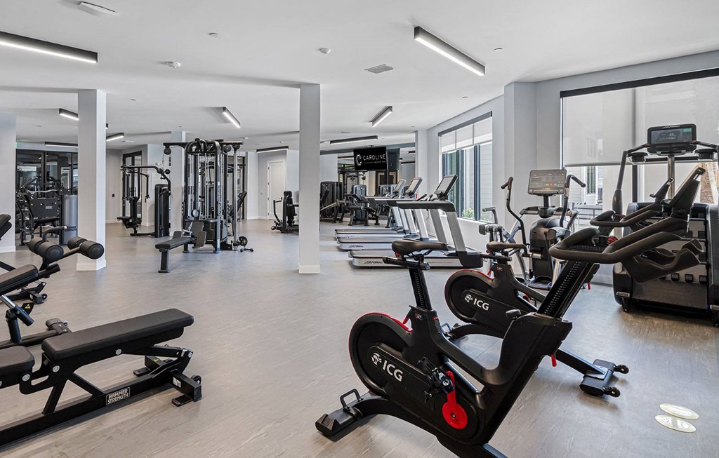 a gym with cardio machines and other exercise equipment at Madison Waterford Lakes, Orlando, FL