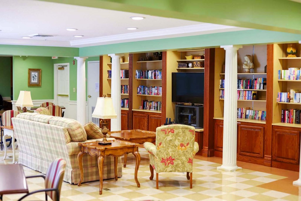 a living room filled with furniture and a book shelf