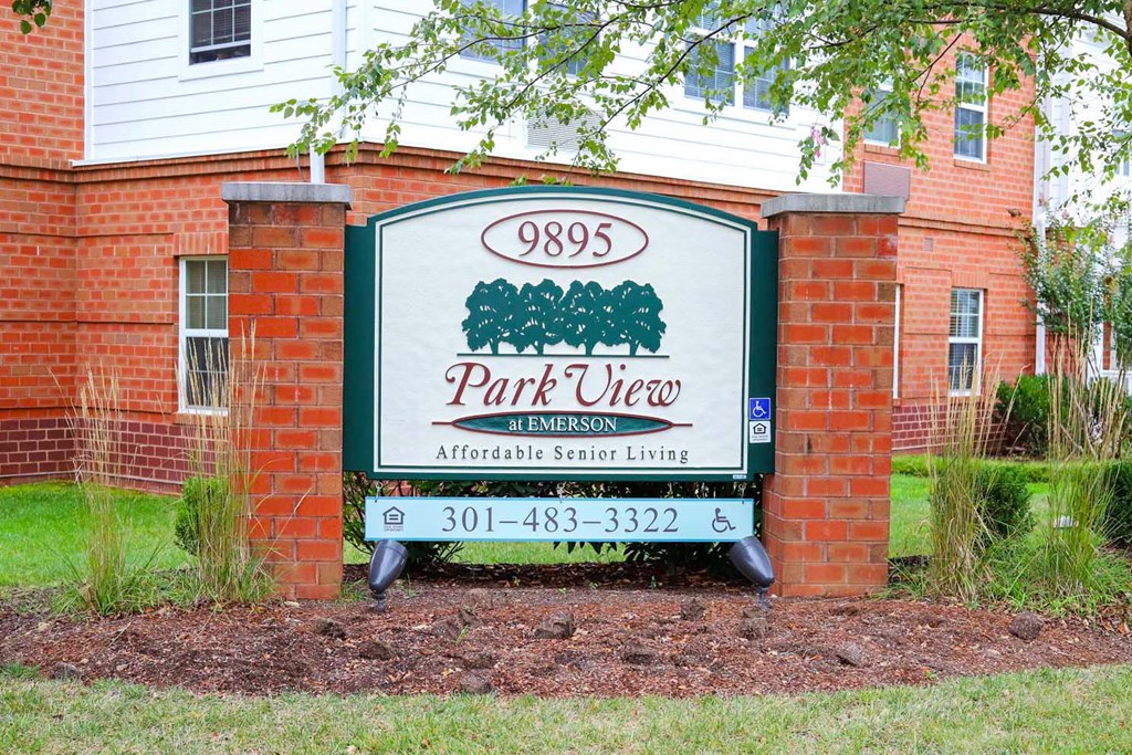 the sign is in front of a brick building