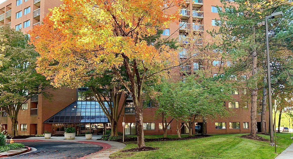 a large brick building with trees in front of it