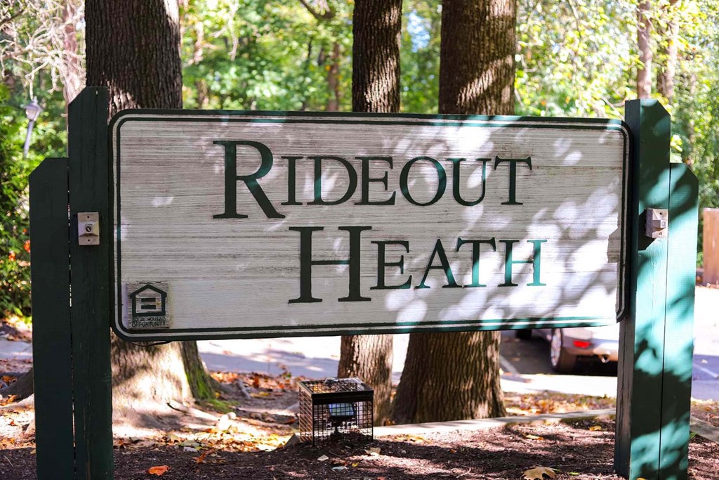 a sign that reads ridout health in front of trees