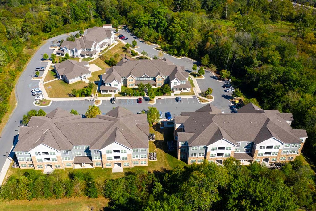 an aerial view of a neighborhood of houses with cars parked