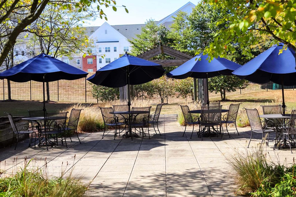 a group of tables with umbrellas on a patio