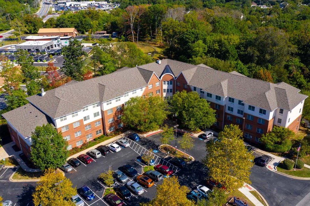 a view of a building from above with a parking lot