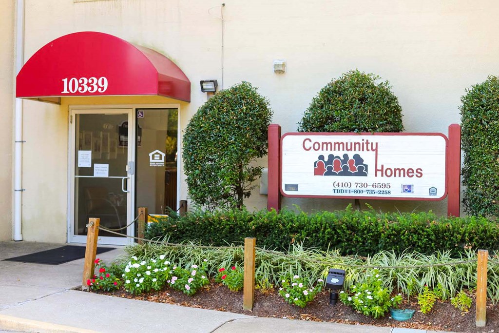 the front of a building with a sign for community homes