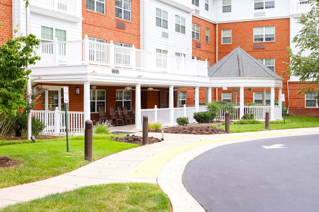 a brick building with a sidewalk in front of it
