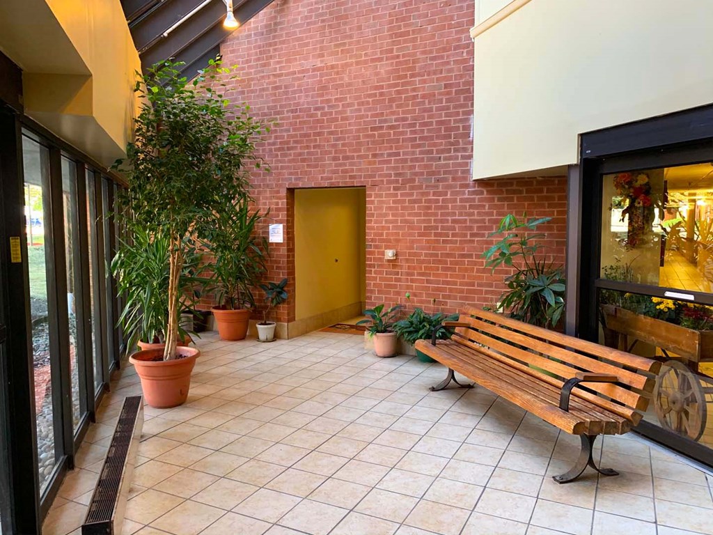 a wooden bench in front of a brick building