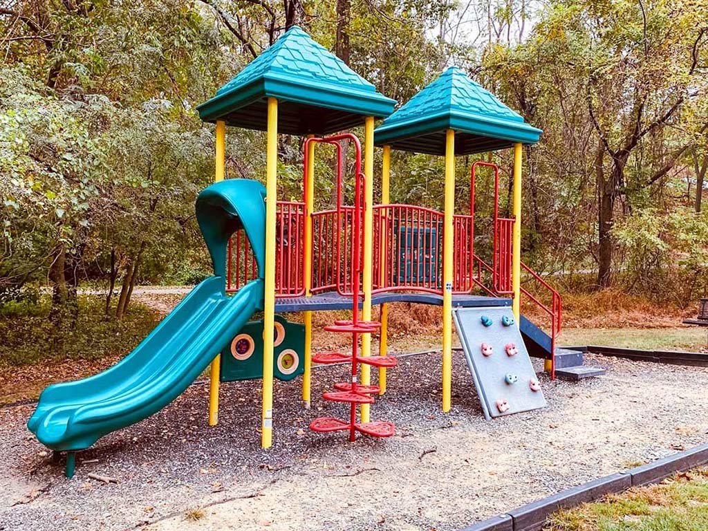 a childrens playground with a slide and   slides