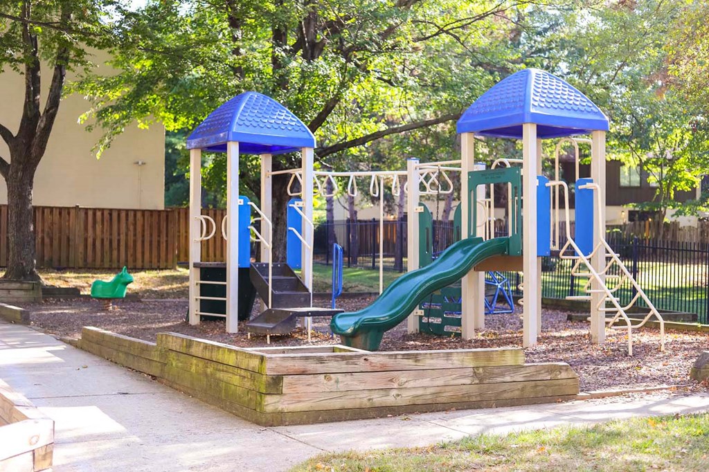 a playground with a slide and other toys in a park