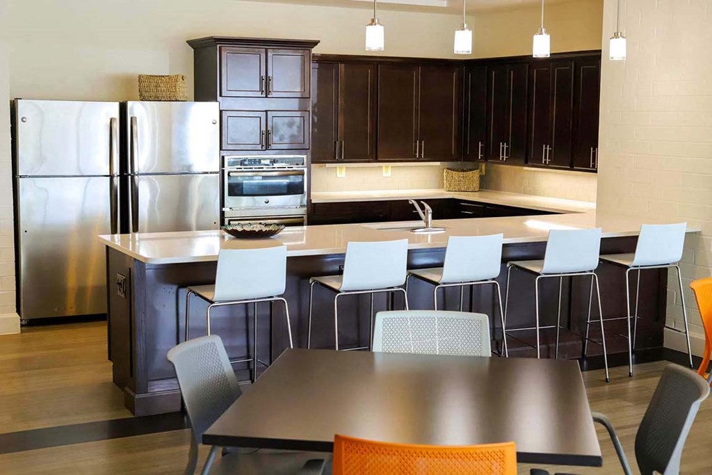 a large kitchen with a table and chairs and a refrigerator