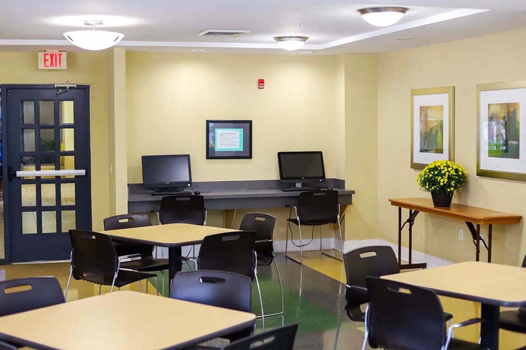 a conference room with tables and chairs and a piano
