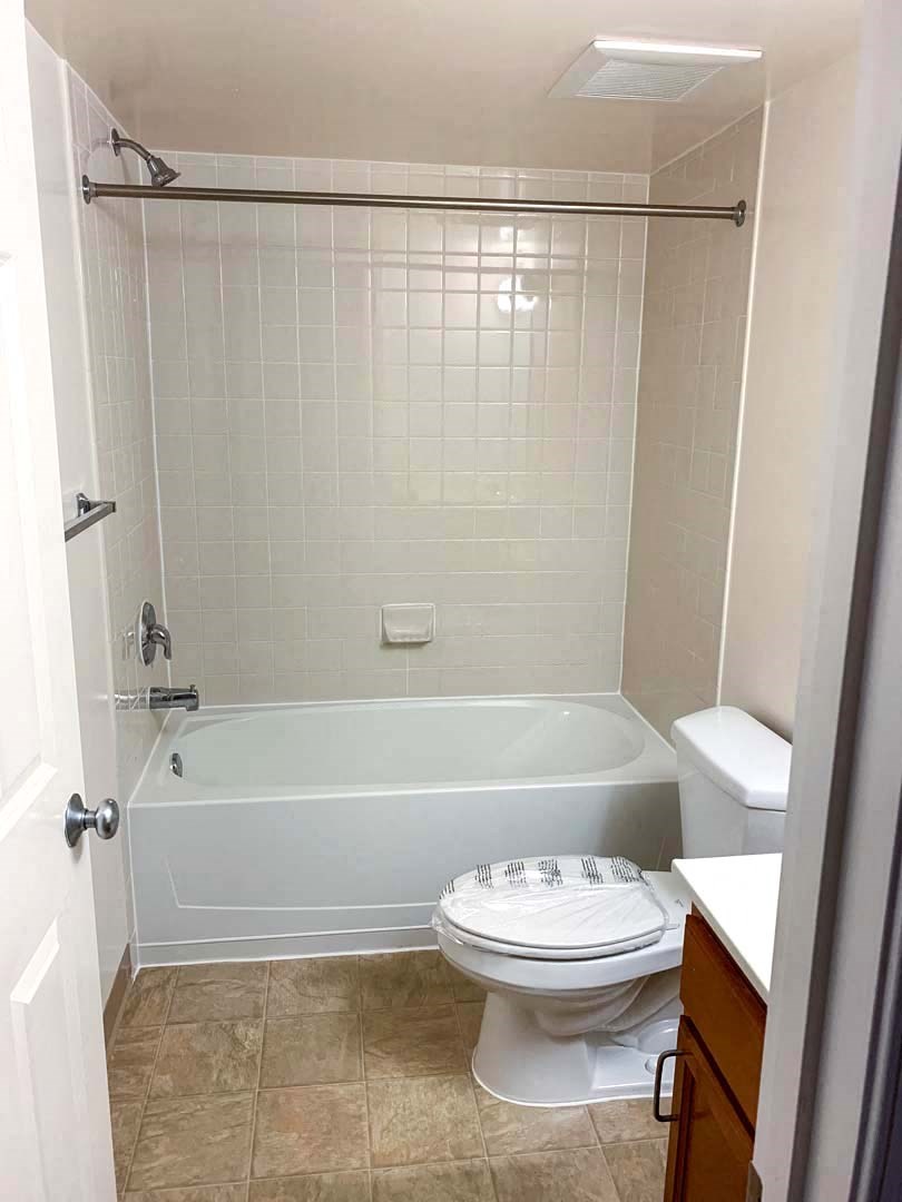 a bathroom with a toilet and a bath tub