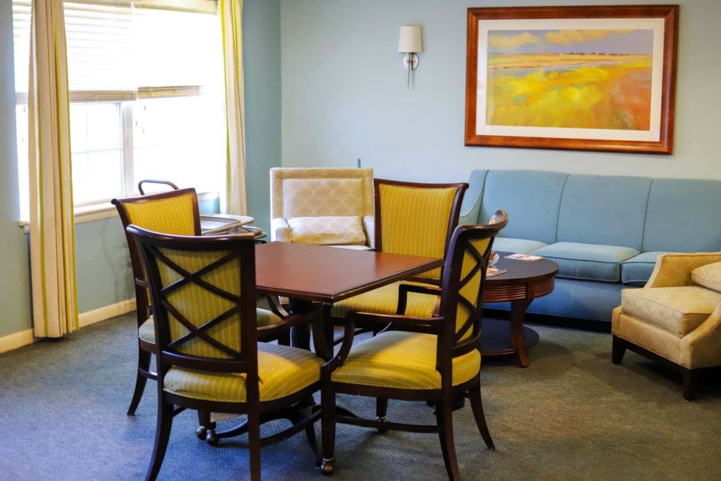a living room with a table and chairs and a couch