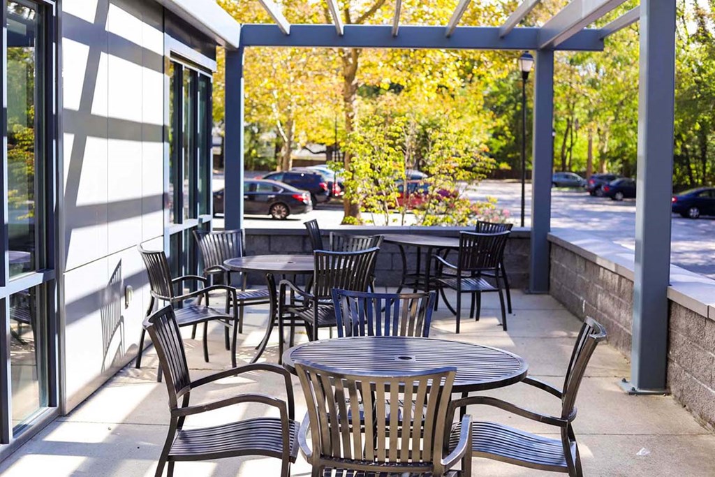 a patio with tables and chairs outside of a restaurant