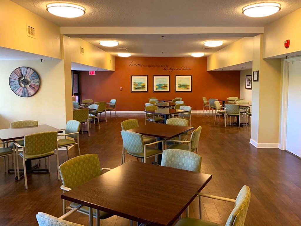 a large dining room with tables and chairs