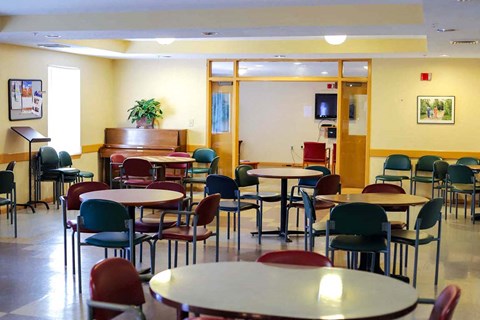 Vibrant community room at Park Heights Place hosting senior activities like bingo and movie nights for residents age 62+.