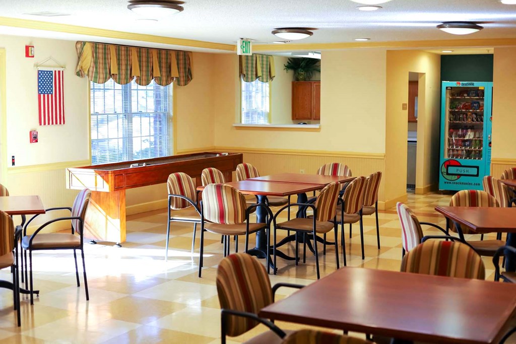 a dining room with tables and chairs and a bar