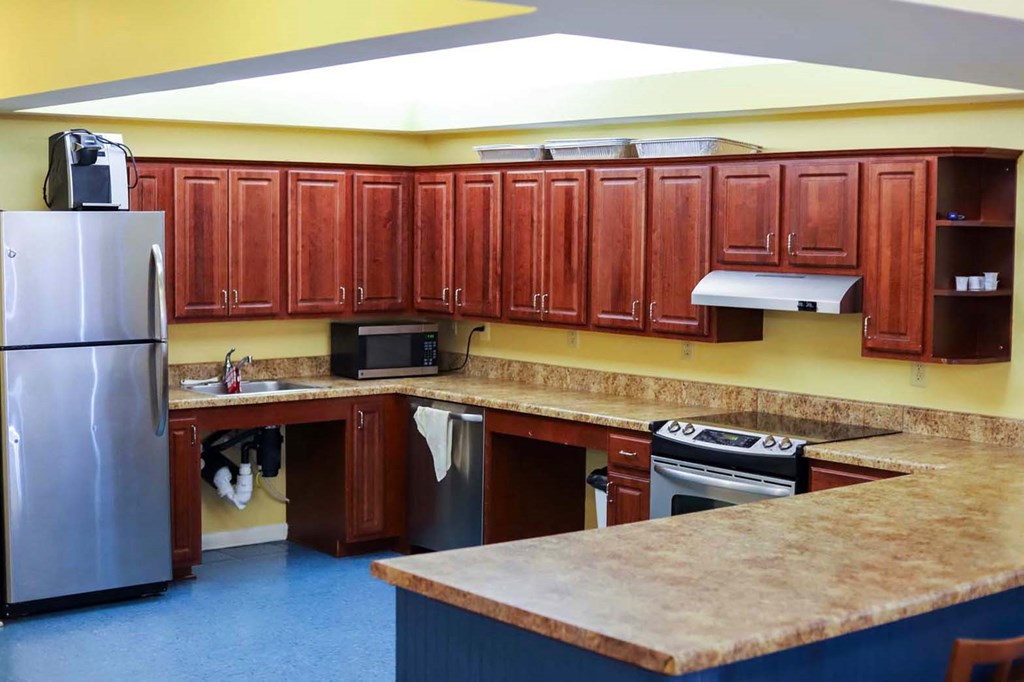 a kitchen with stainless steel appliances and wooden cabinets