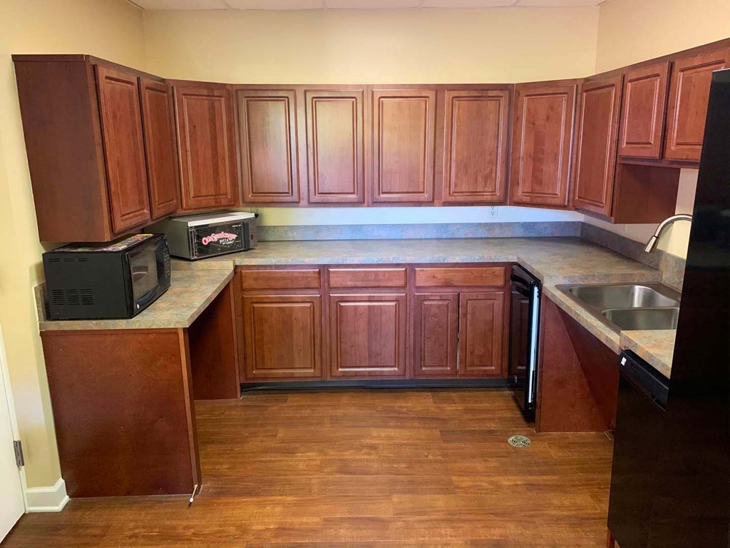 an empty kitchen with wooden cabinets and a sink