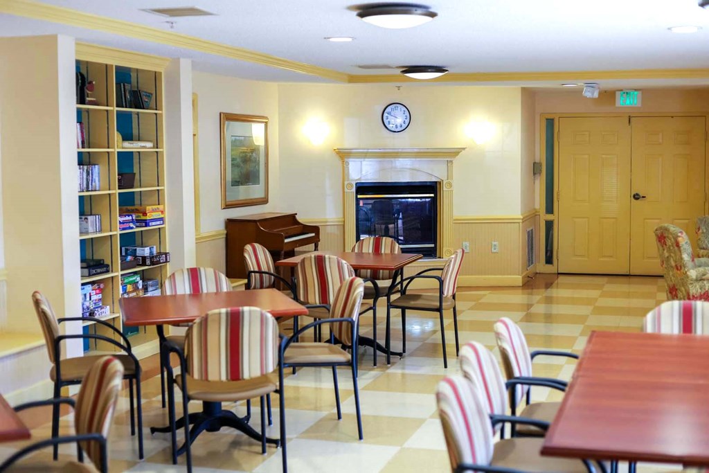a dining room with tables and chairs and a fireplace
